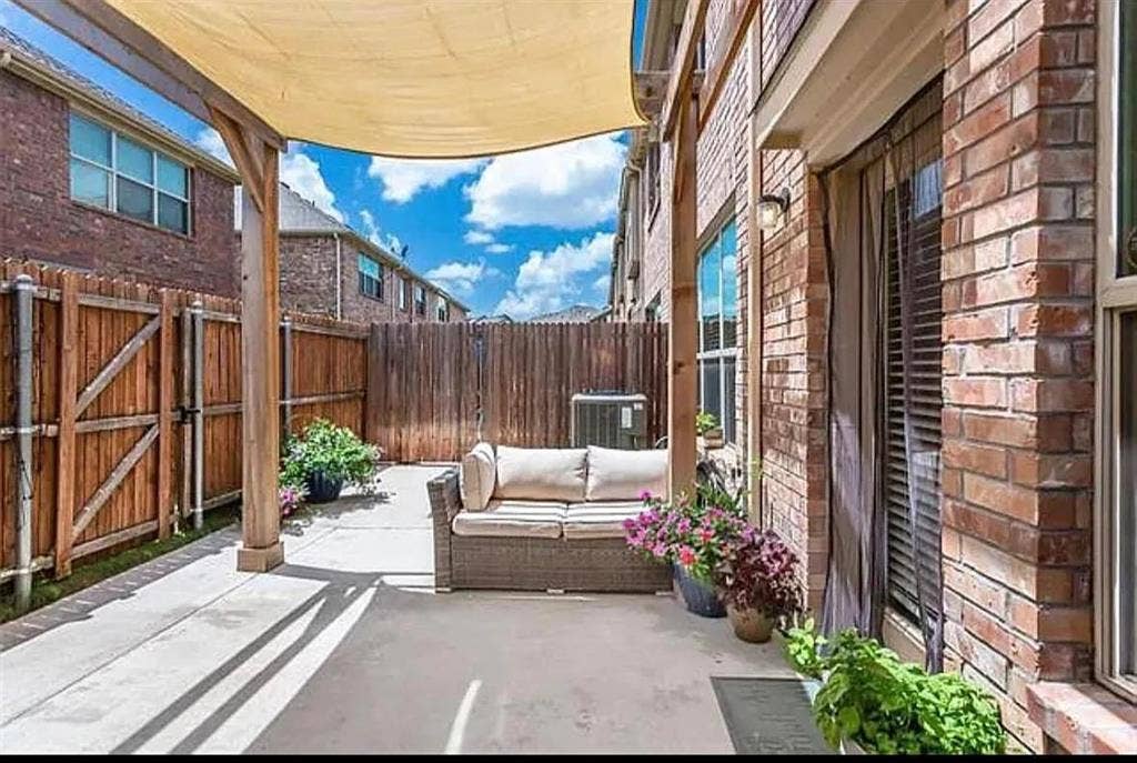View of patio with an outdoor living space and central AC