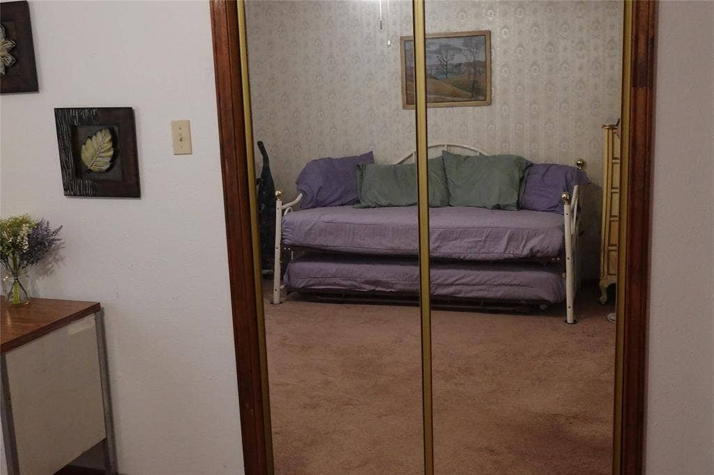 Mirrored closet doors with wood-finish framing