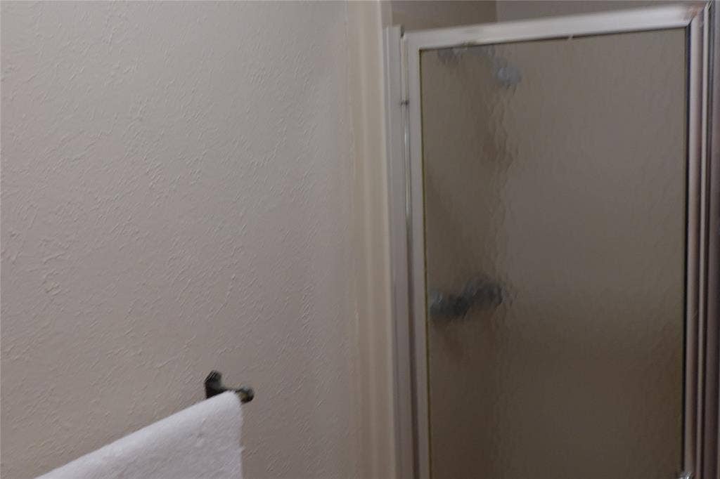 Shower enclosure with frosted glass and metal framing