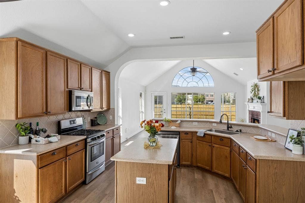 Warm cabinetry, expansive counter space, and versatile center island make this welcoming kitchen a natural gathering place - perfect for entertaining family and friends during the upcoming holidays!