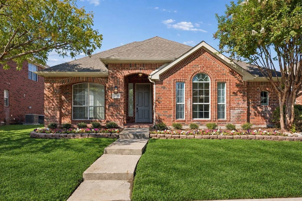Picture-perfect curb appeal! Graceful brick arches, beautifully framed windows, and beautiful landscaping create an unforgettable first impression!