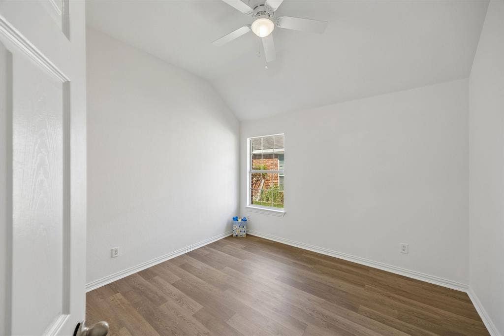 This is the 3rd bedroom... you will still find the vaulted ceiling, warm flooring and new ceiling fan!