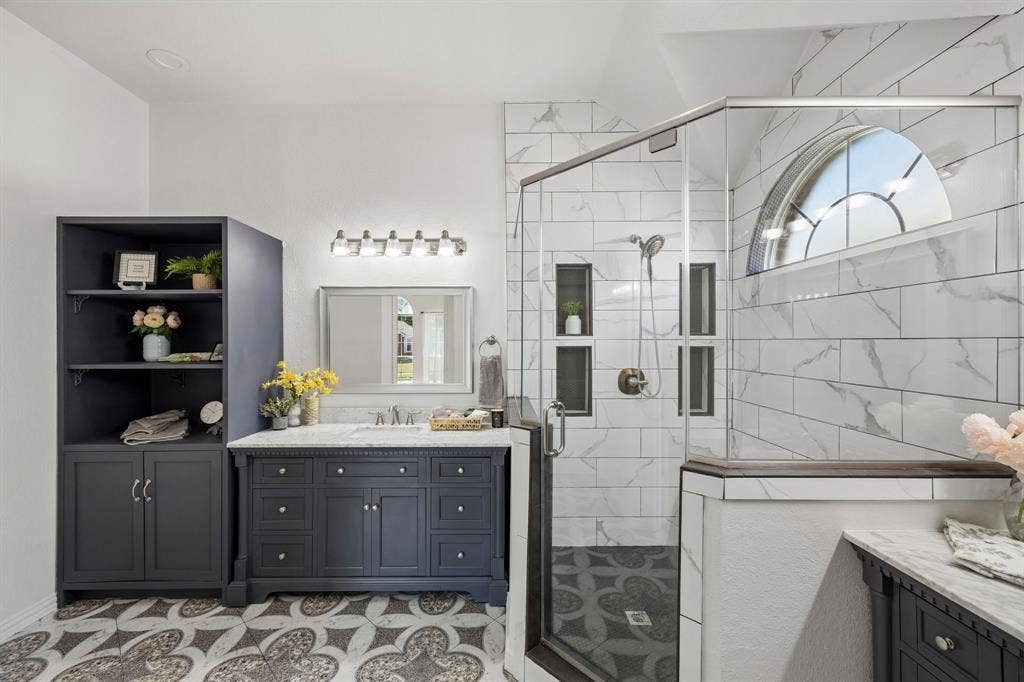 Elegant cabinetry, distinctive designer-inspired flooring, and a beautifully tiled walk-in shower create  a relaxing, refined atmosphere!