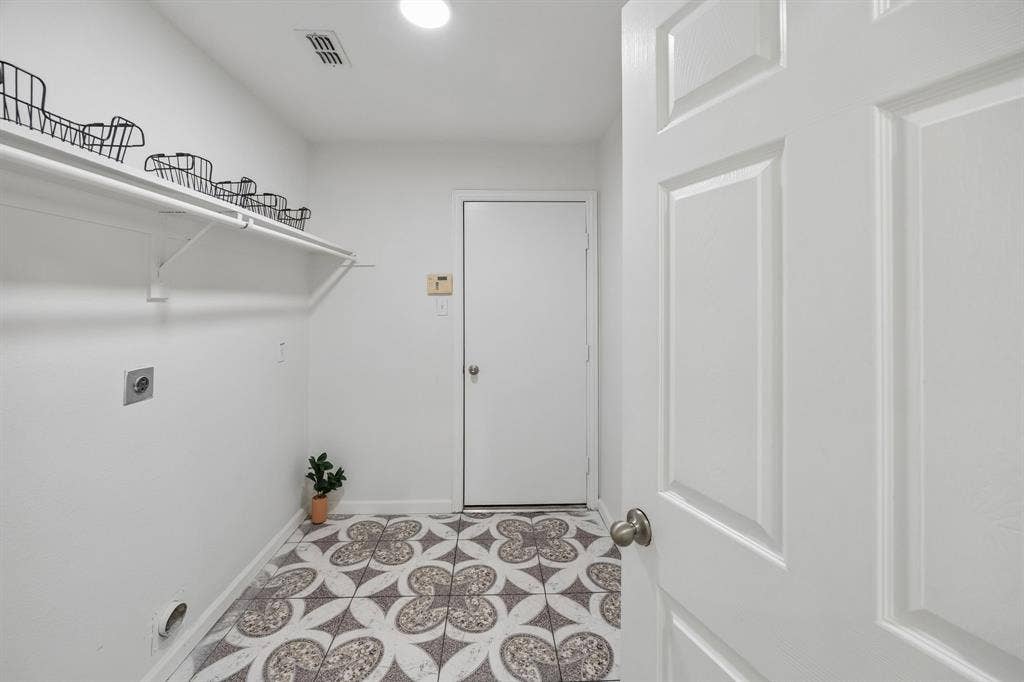This oversized Laundry room is perfect!  Plenty of room for hanging clothes and shelves for storage-it provides a "mud room" from the garage, too!