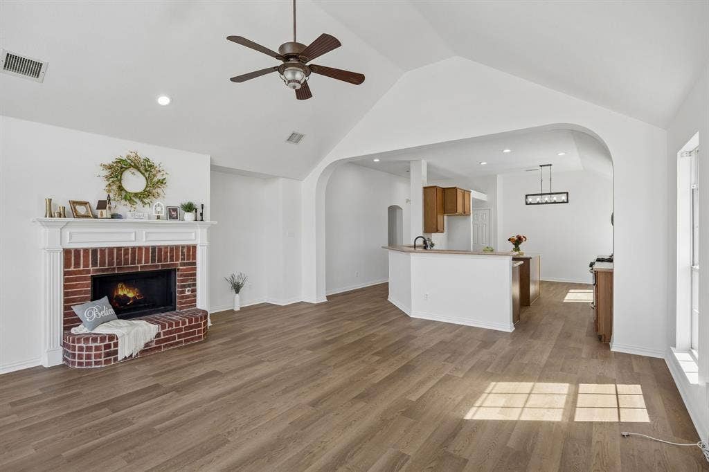 This photo captures the open and bright concept this home offers as well as the stunning vaulted ceiling, and architectural details that bring the warmth to this home - family and friends alike will love spending time here!