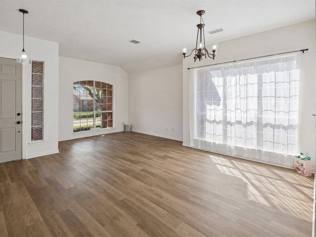 This inviting area features an arched window and a room full of possibilities!