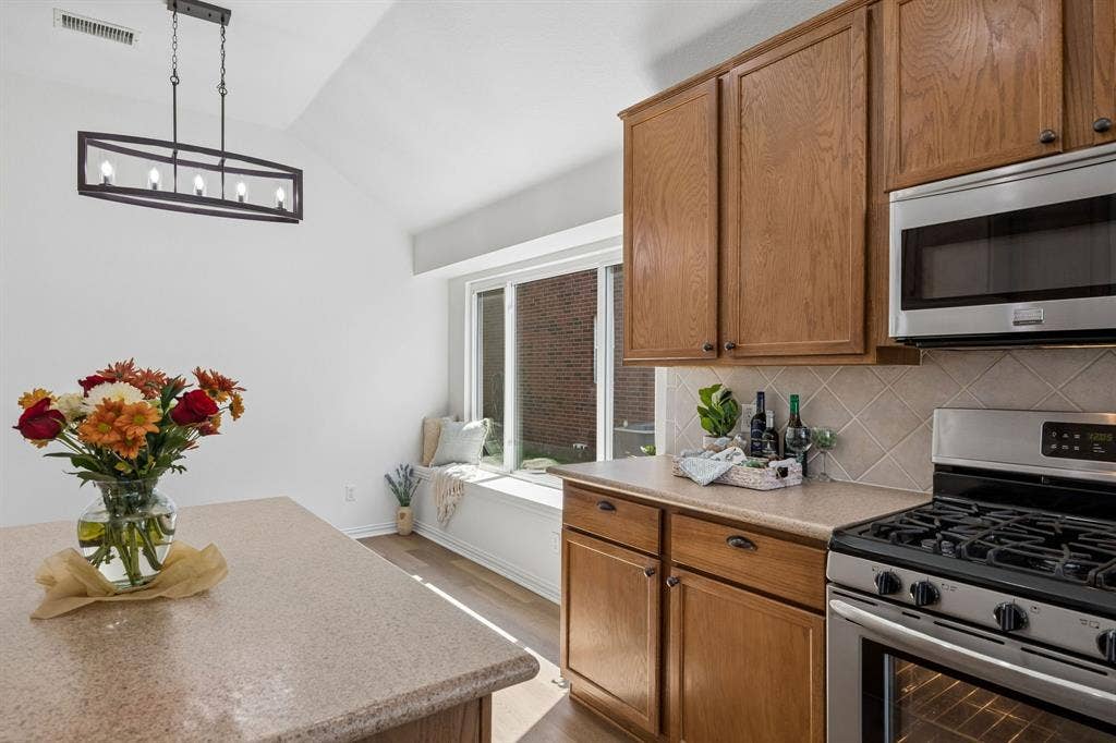 This view shows the beautiful counter tops, lovely backsplash and cabinetry as we look towards the breakfast room!