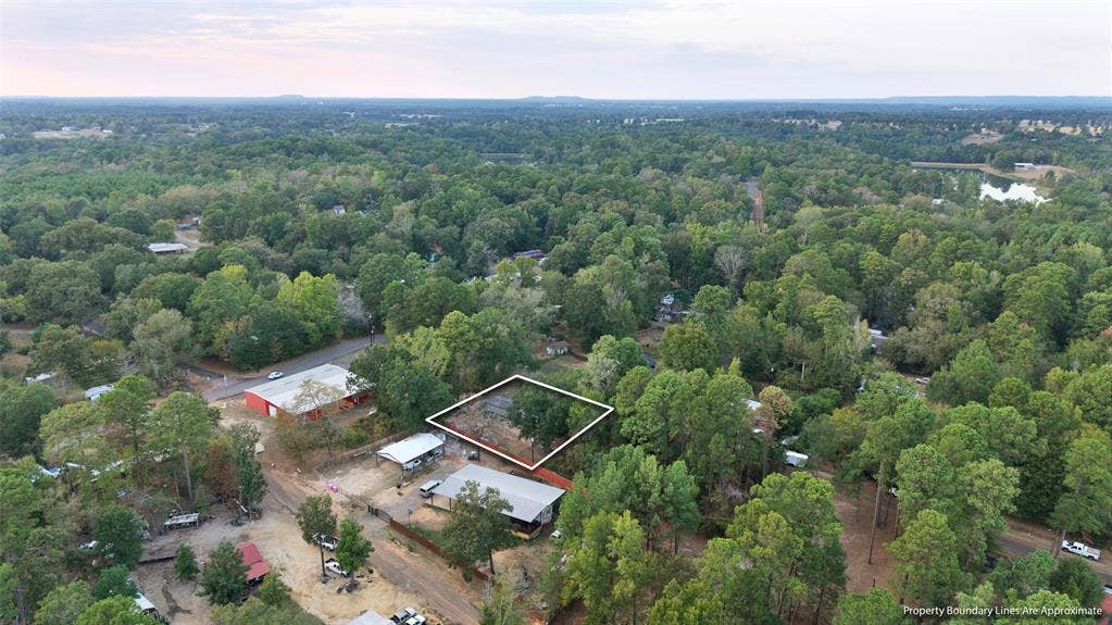 Wooded parcel with surrounding mature trees and distant water feature