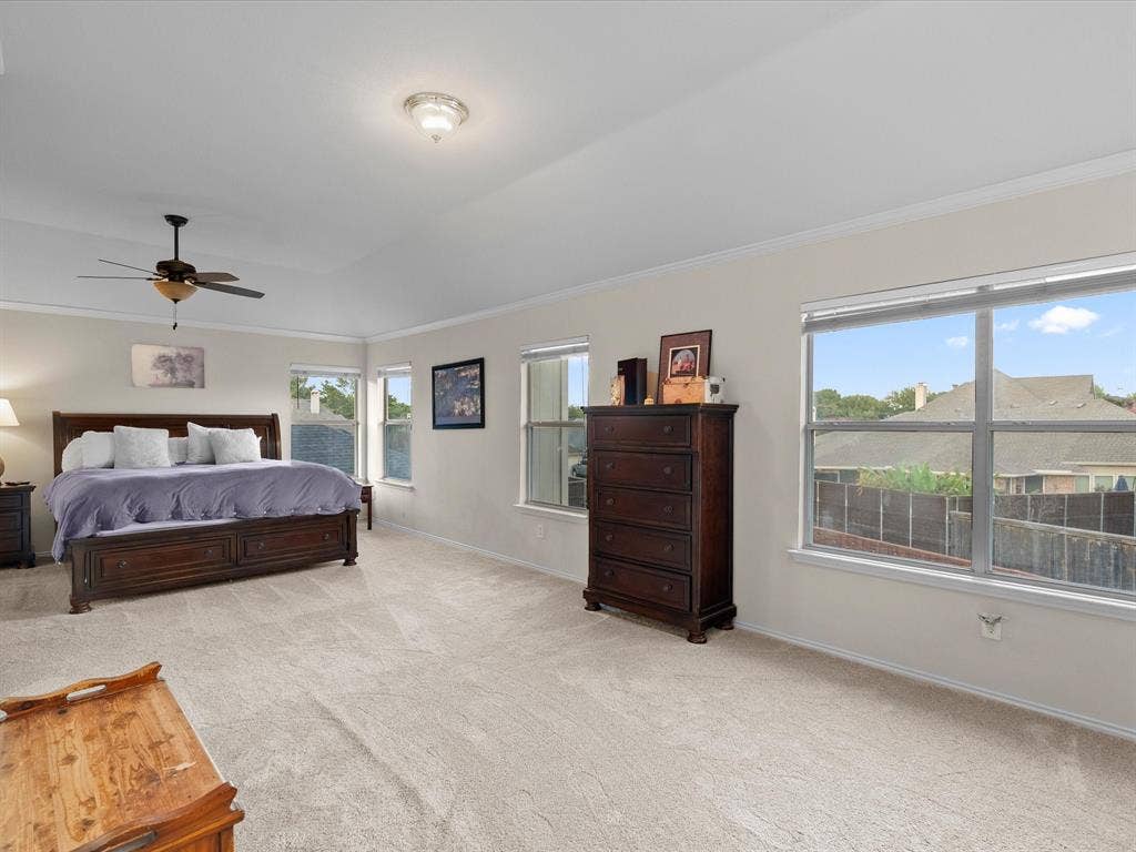 3303 Felicia Court, McKinney, TX 75070 High tray ceiling, neutral carpeting, and large windows providing natural light, completed by a ceiling fan with integrated lighting