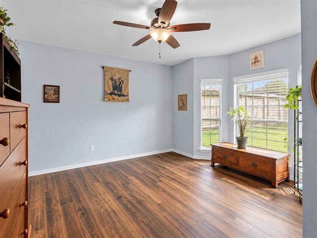3303 Felicia Court, McKinney, TX 75070 Wood-finish flooring, bay window configuration, and a ceiling-mounted fan with integrated lighting