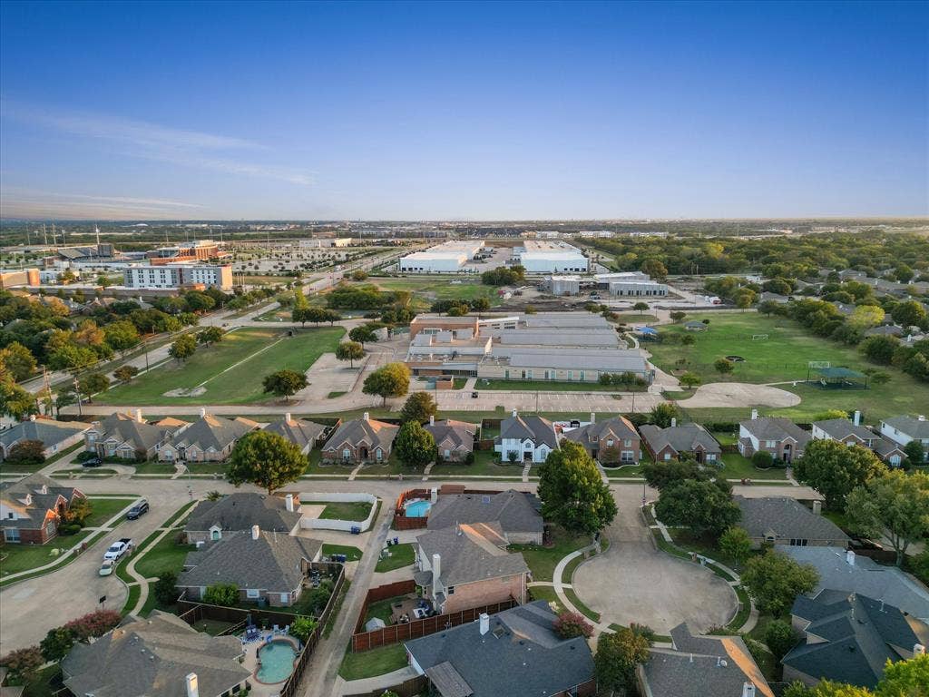 3303 Felicia Court, McKinney, TX 75070 Aerial perspective of a suburban neighborhood featuring winding residential streets, established trees, and proximity to expansive open green space