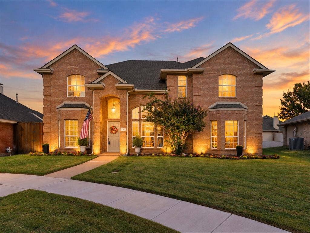 3303 Felicia Court, McKinney, TX 75070 Brick exterior featuring a multi-gabled roofline, arched window detailing, and a prominent recessed entryway