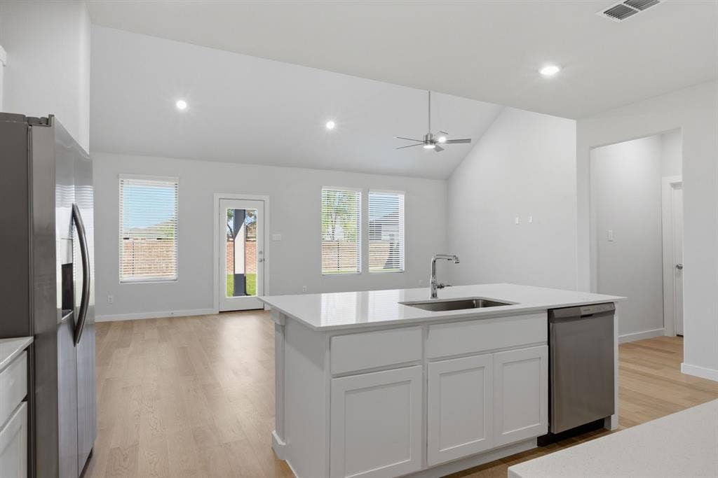 637 Sierra Ridge, Lavon, TX 75166 Kitchen island with an undermount sink, stainless steel dishwasher, and white cabinetry