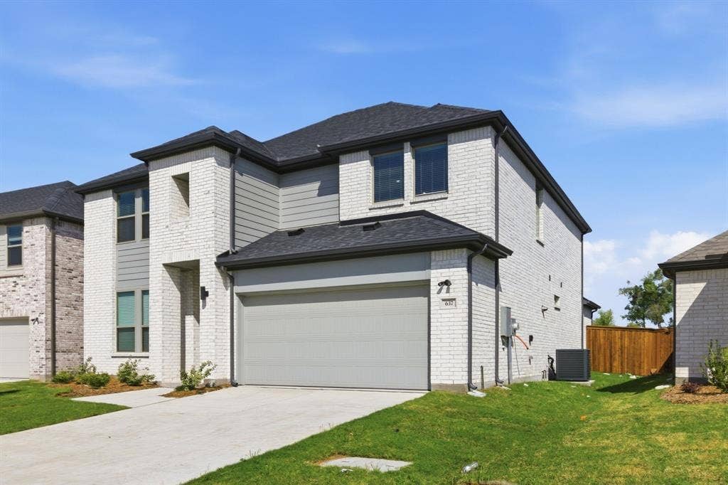 637 Sierra Ridge, Lavon, TX 75166 Brick and siding exterior with dark trim accents, a concrete driveway, and an attached garage