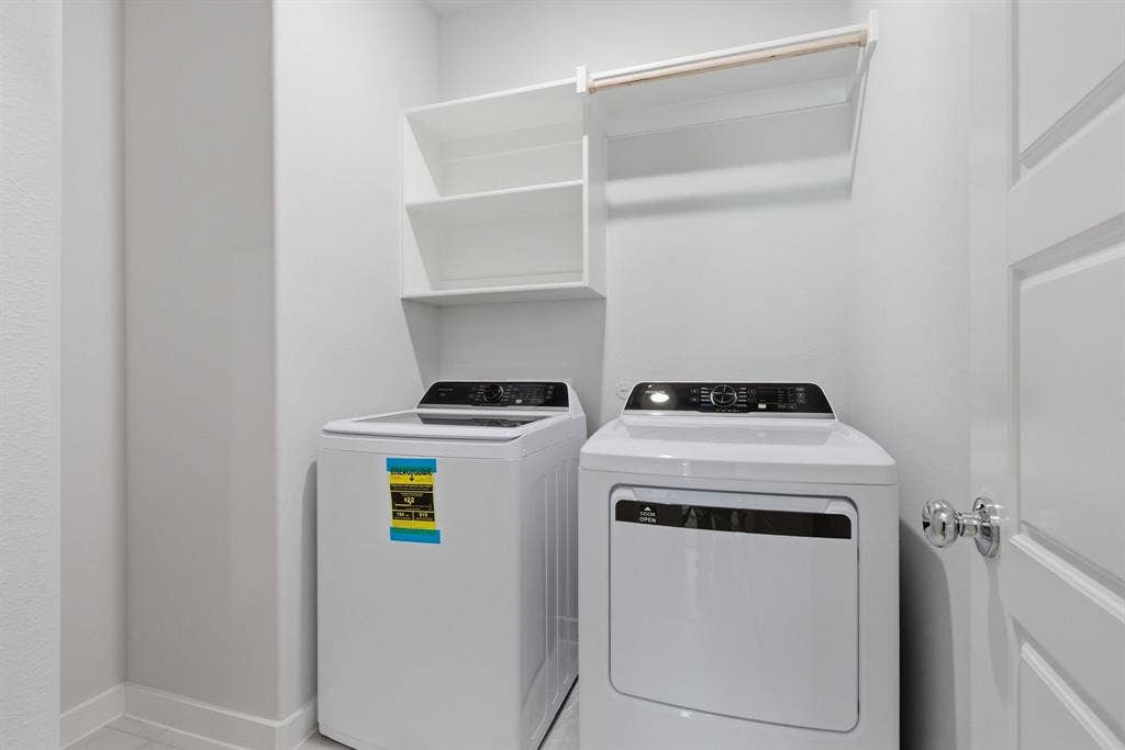 637 Sierra Ridge, Lavon, TX 75166 Laundry area with built-in shelving and hanging rod