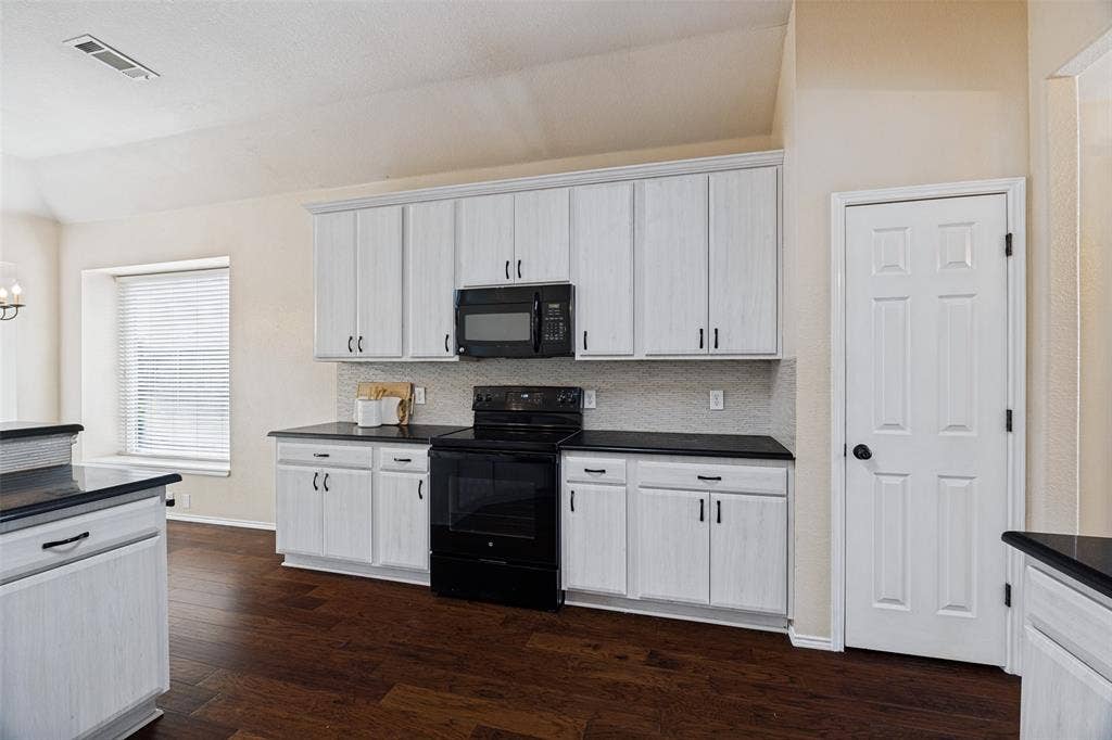Kitchen featuring new cabinets and granite counters