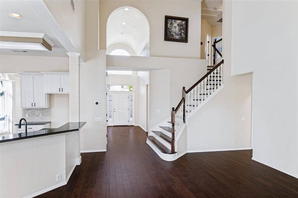 Front of home featuring high ceilings, engineered wood flooring