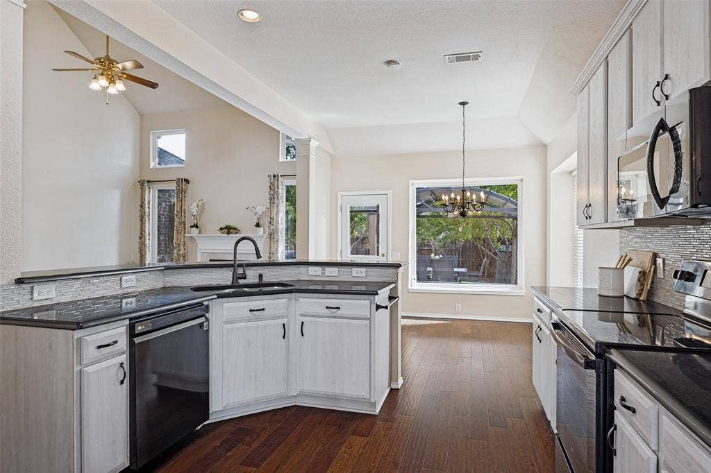 Kitchen looking into breakfast area and back yard