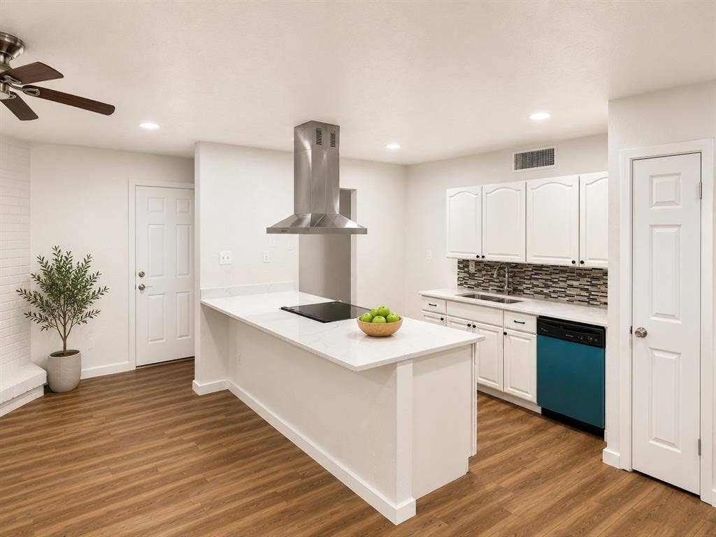 542 Hanover Drive, Allen, TX 75002 Kitchen featuring a central island with cooktop, stainless steel range hood, white cabinetry, mosaic tile backsplash, and wood-finish flooring