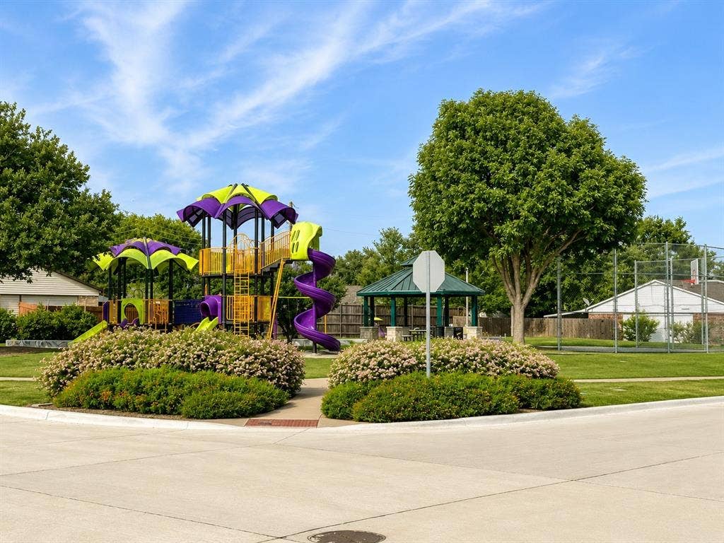 542 Hanover Drive, Allen, TX 75002 Community park featuring a vibrant multi-level playground, a shaded gazebo, and a basketball court