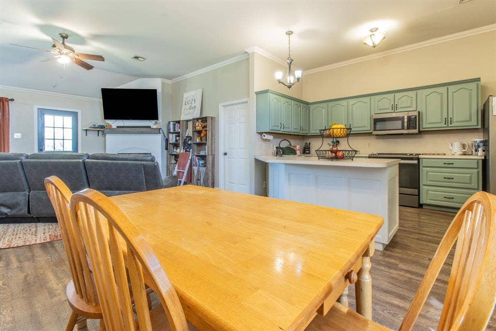 Spacious kitchen featuring painted cabinetry, stainless steel appliances, and a central island