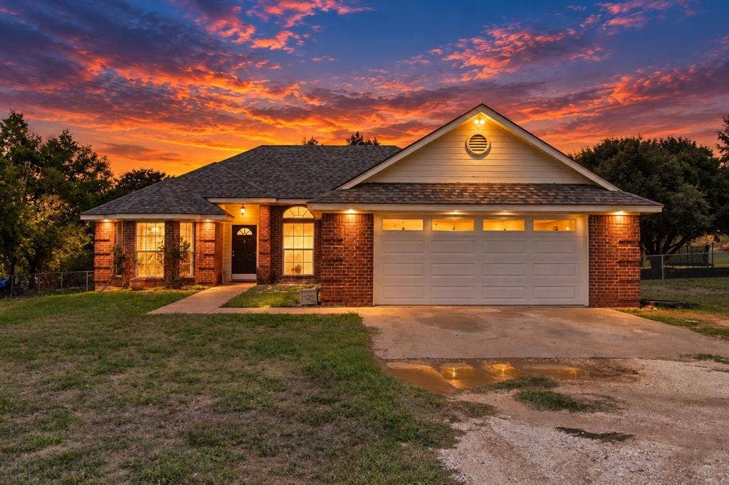 Brick exterior with white siding accents and a pitched roof