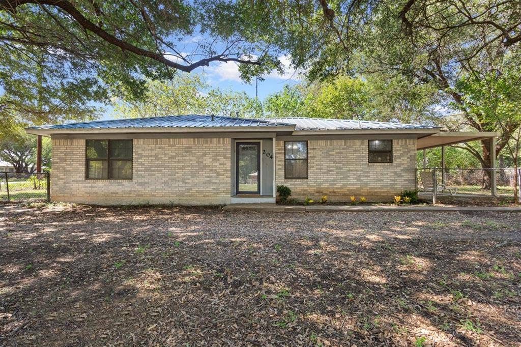 204 Ausborn Street, Eddy, TX 76524 Brick exterior with a corrugated metal roof
