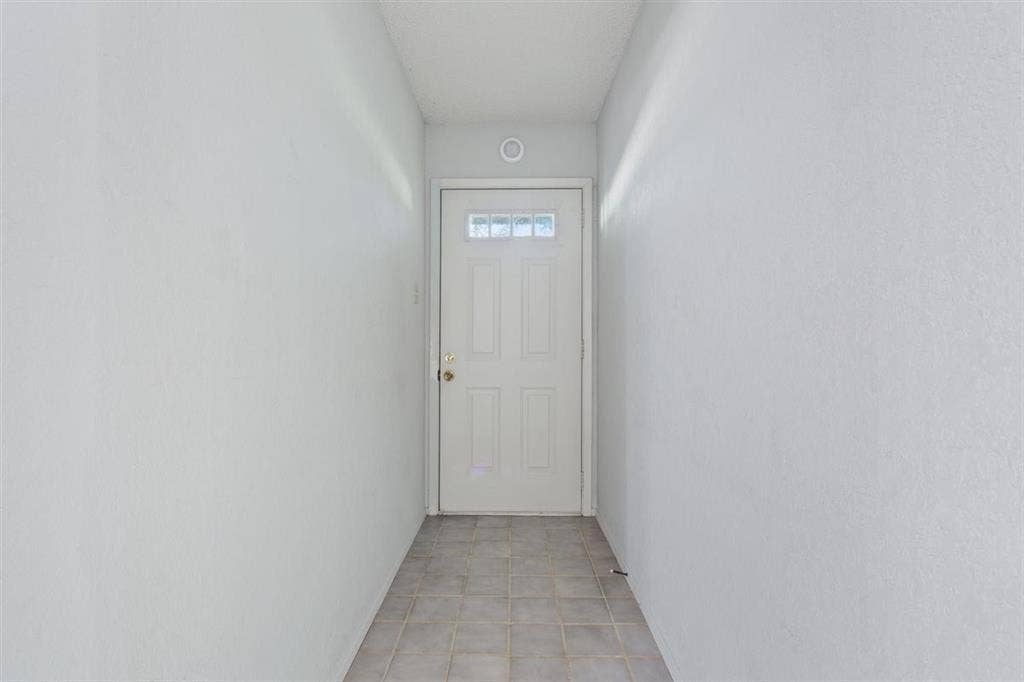 204 Ausborn Street, Eddy, TX 76524 Entryway featuring a white paneled door with decorative glass inserts, recessed ceiling lighting, and neutral tone tile flooring