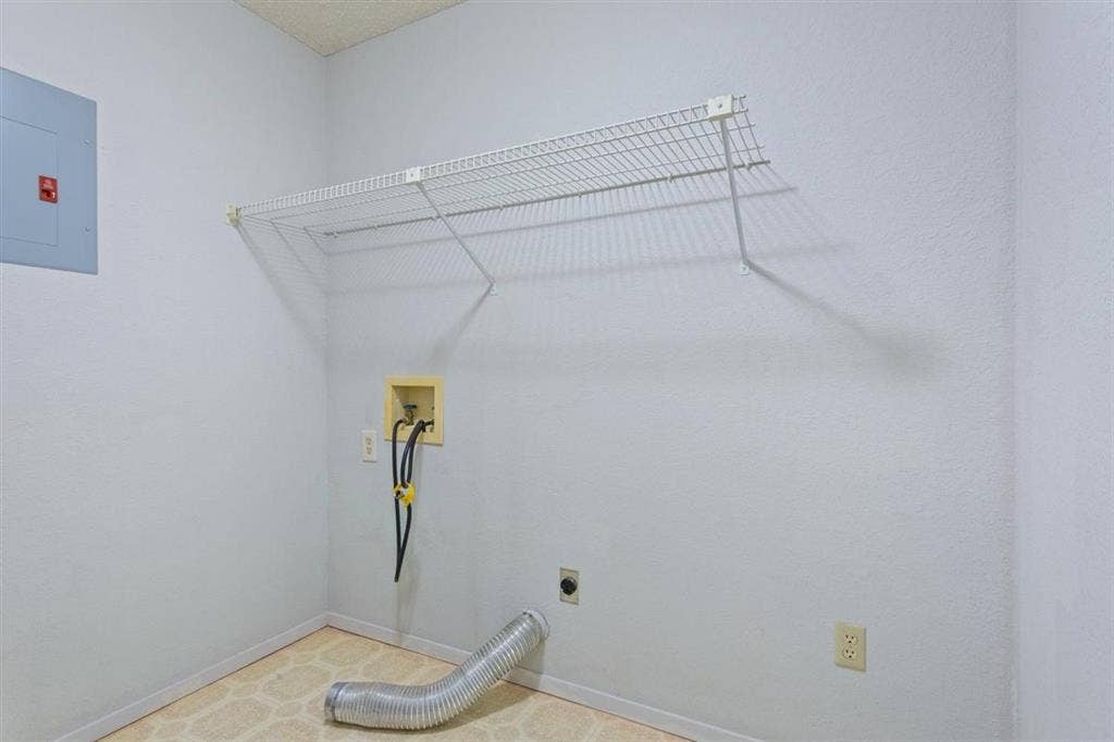 204 Ausborn Street, Eddy, TX 76524 Laundry area featuring a wire storage shelf, utility hookups, and a light-colored patterned floor