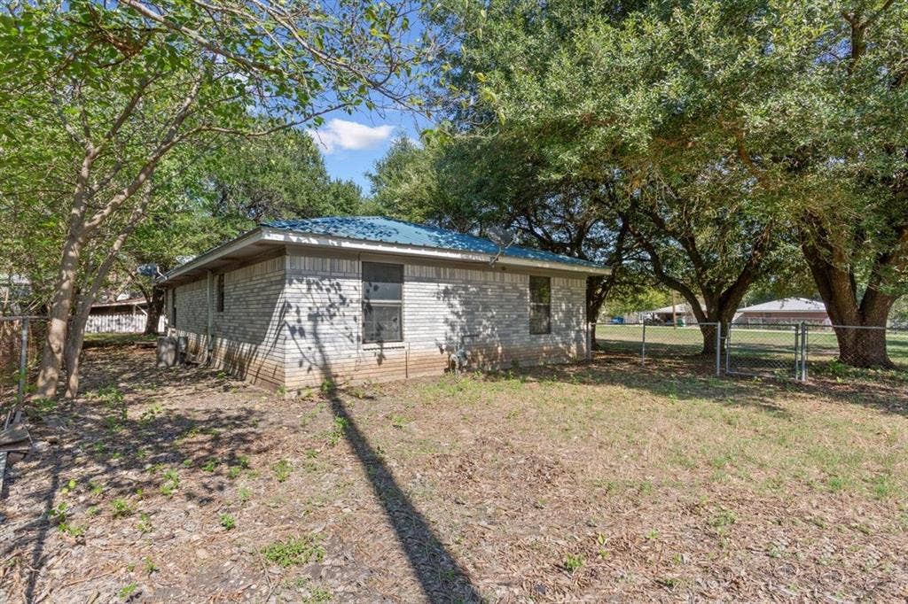 204 Ausborn Street, Eddy, TX 76524 Stone exterior with a blue metal roof