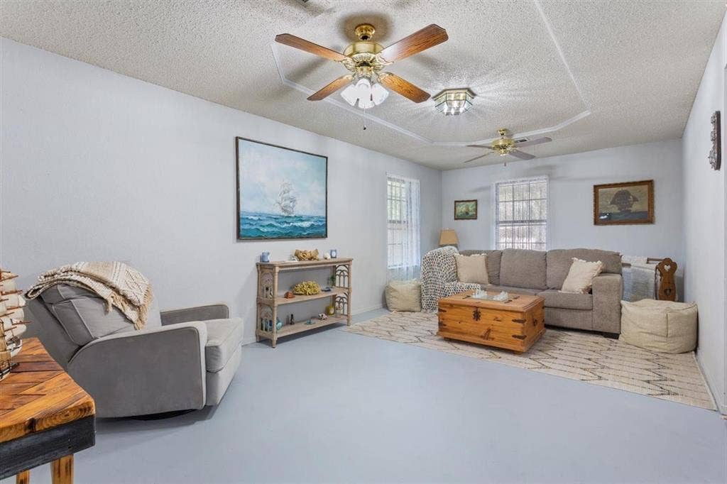204 Ausborn Street, Eddy, TX 76524 Recessed ceiling detail, multiple ceiling fans, light-toned walls, and abundant natural light
