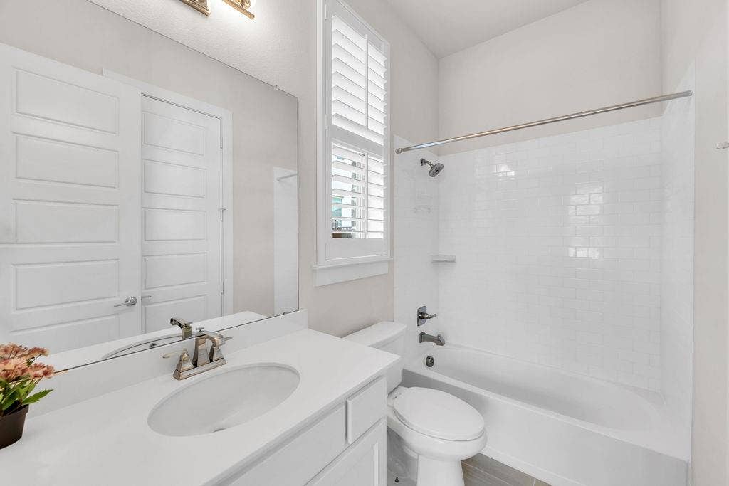 2971 Gaulding Drive, Prosper, TX 75078 White shaker vanity with an integrated sink, brushed nickel faucet, and a large wall-mounted mirror