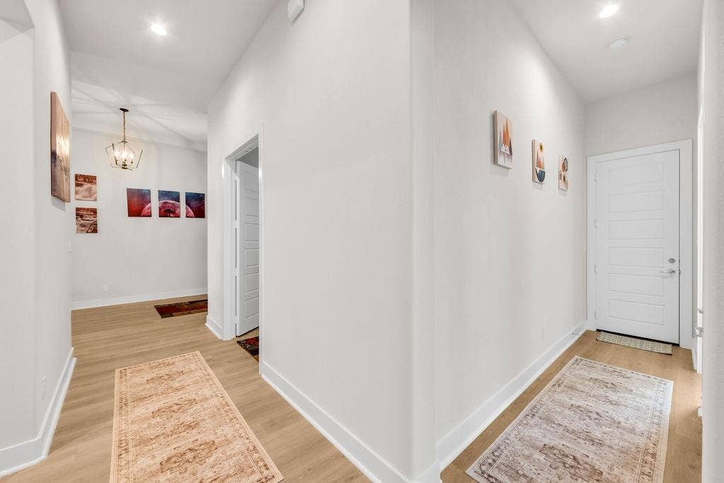 2971 Gaulding Drive, Prosper, TX 75078 Hallway featuring wood-finish flooring, recessed lighting, a paneled door, and a geometric chandelier