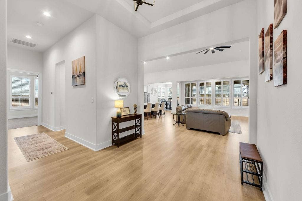 2971 Gaulding Drive, Prosper, TX 75078 Expansive open-concept living area featuring light wood-finish flooring, recessed lighting, and a ceiling fan