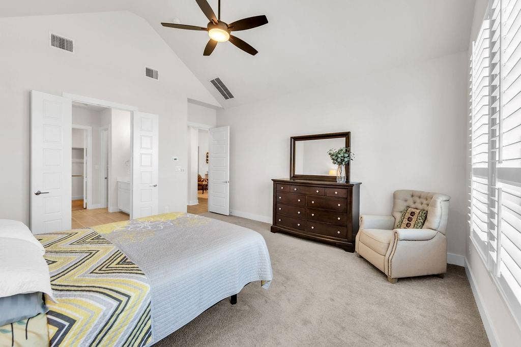 2971 Gaulding Drive, Prosper, TX 75078 Vaulted ceiling with a ceiling fan, white plantation shutters, and carpet flooring