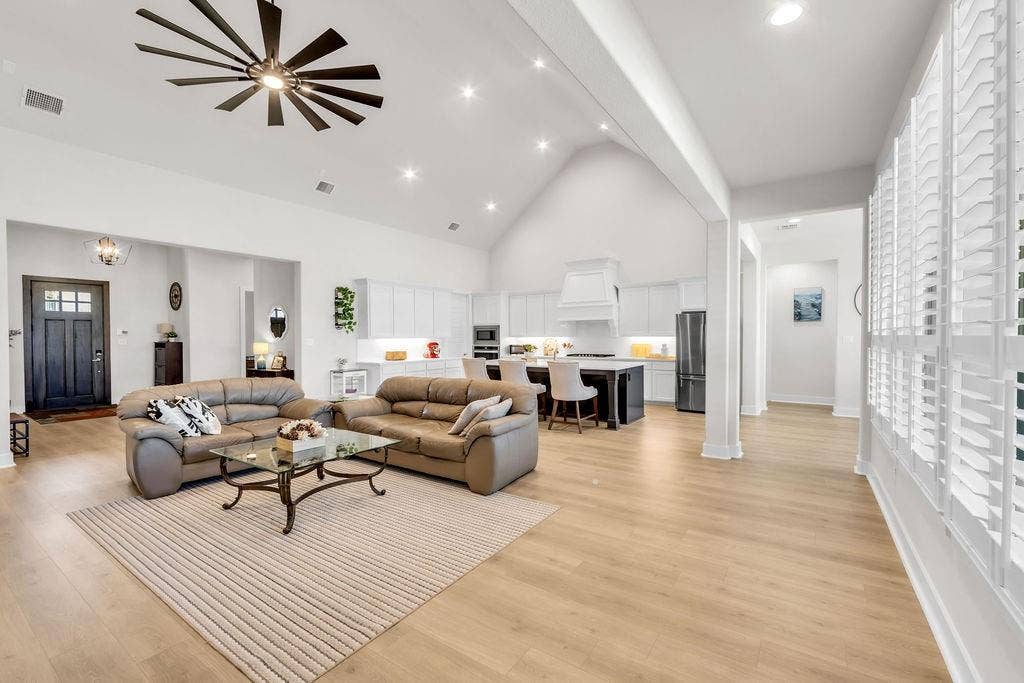 2971 Gaulding Drive, Prosper, TX 75078 Vaulted ceiling, recessed lighting, wood-finish flooring, plantation shutters, and a modern ceiling fan