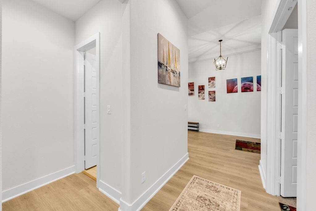 2971 Gaulding Drive, Prosper, TX 75078 Wood-finish flooring throughout, white walls, and a recessed doorway