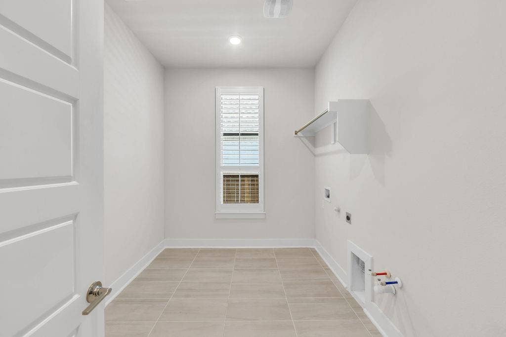 2971 Gaulding Drive, Prosper, TX 75078 Laundry room with a single window, overhead lighting, and a built-in shelf with hanging rod