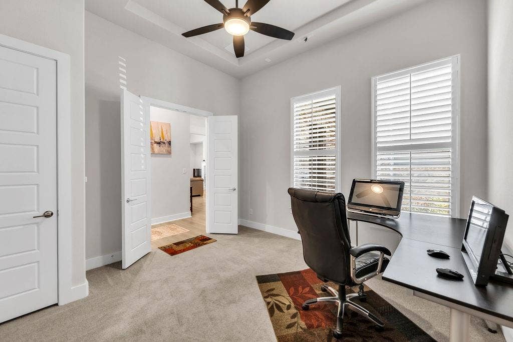 2971 Gaulding Drive, Prosper, TX 75078 Tray ceiling with a ceiling fan, two windows with plantation shutters, light-colored carpeting, and a double-door entryway