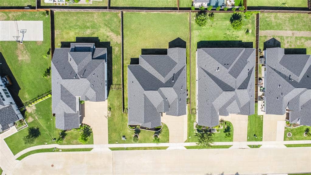 2971 Gaulding Drive, Prosper, TX 75078 Paved street frontage with a curved sidewalk, asphalt shingle roofing, and grass lawns