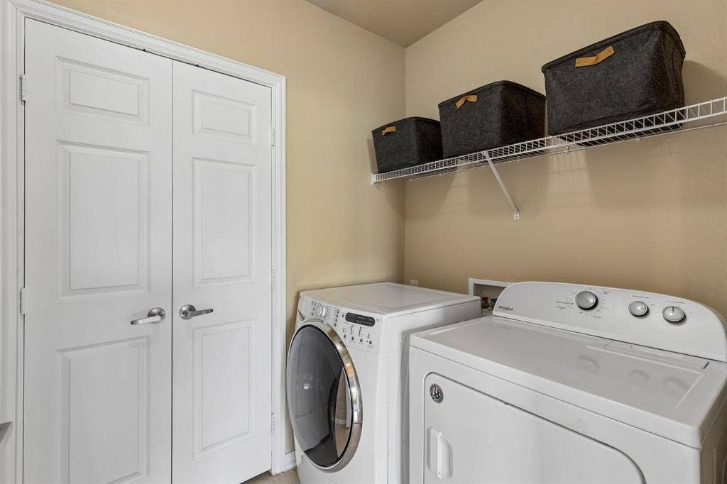 Laundry day made easy! Enjoy a dedicated laundry room with washer, dryer, and overhead storage.