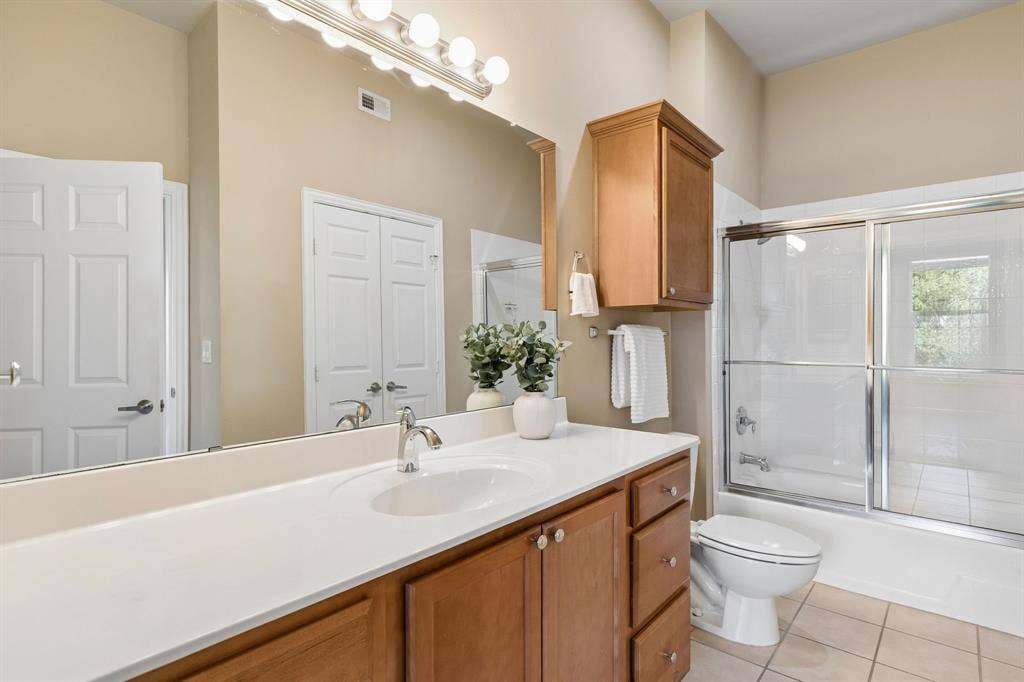 A bright, welcoming bathroom with a full tub and shower combination.
