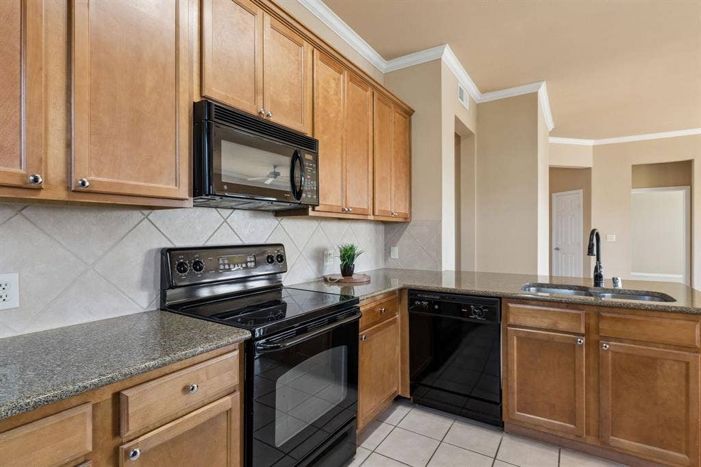 Everything within reach! Enjoy generous storage, black appliances, and an efficient kitchen layout.