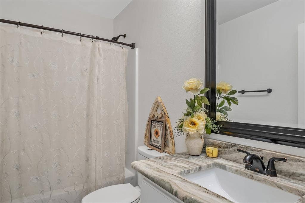 19731 County Road 4130, Lindale, TX 75771 Integrated vanity with an undermount sink, patterned countertop, and a dark-toned faucet