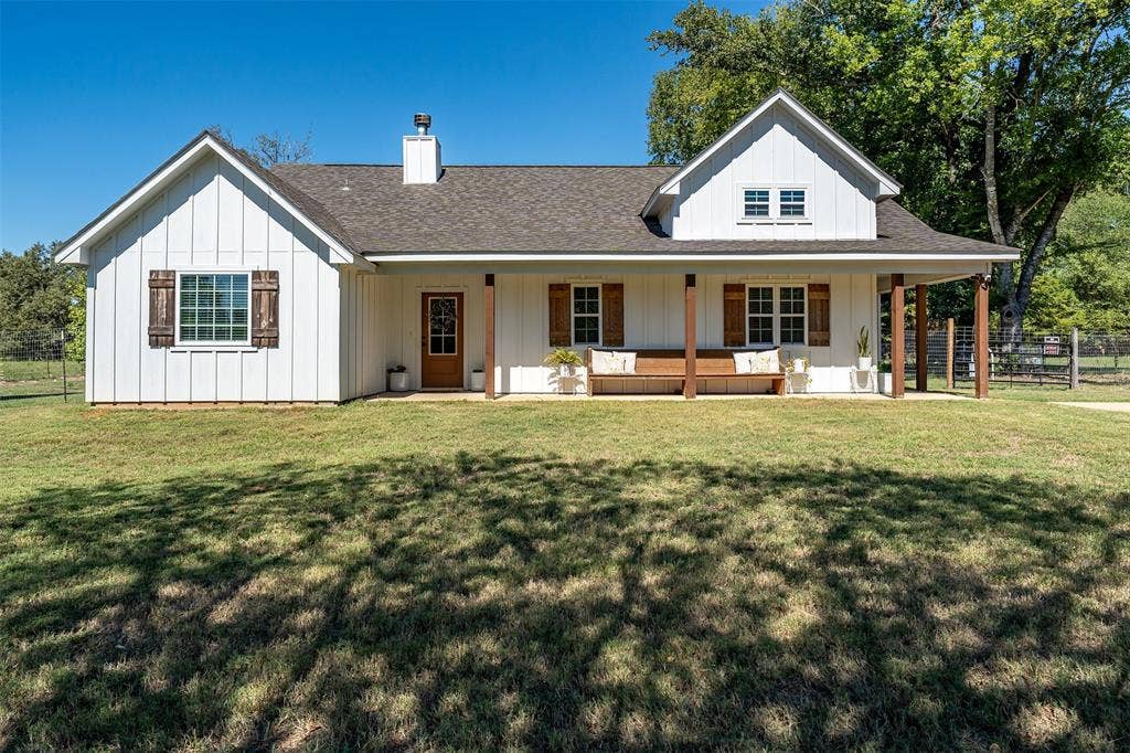 19731 County Road 4130, Lindale, TX 75771 White board and batten exterior with a dark shingled roof