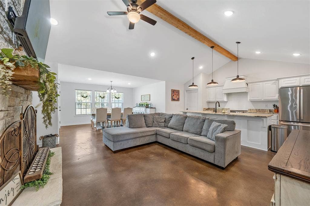 19731 County Road 4130, Lindale, TX 75771 Vaulted ceiling with an exposed wood beam, recessed lighting, and a ceiling fan