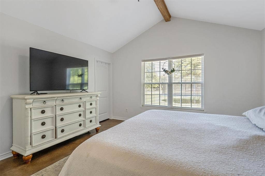19731 County Road 4130, Lindale, TX 75771 Vaulted ceiling with an exposed wood beam, large window with blinds, and durable flooring