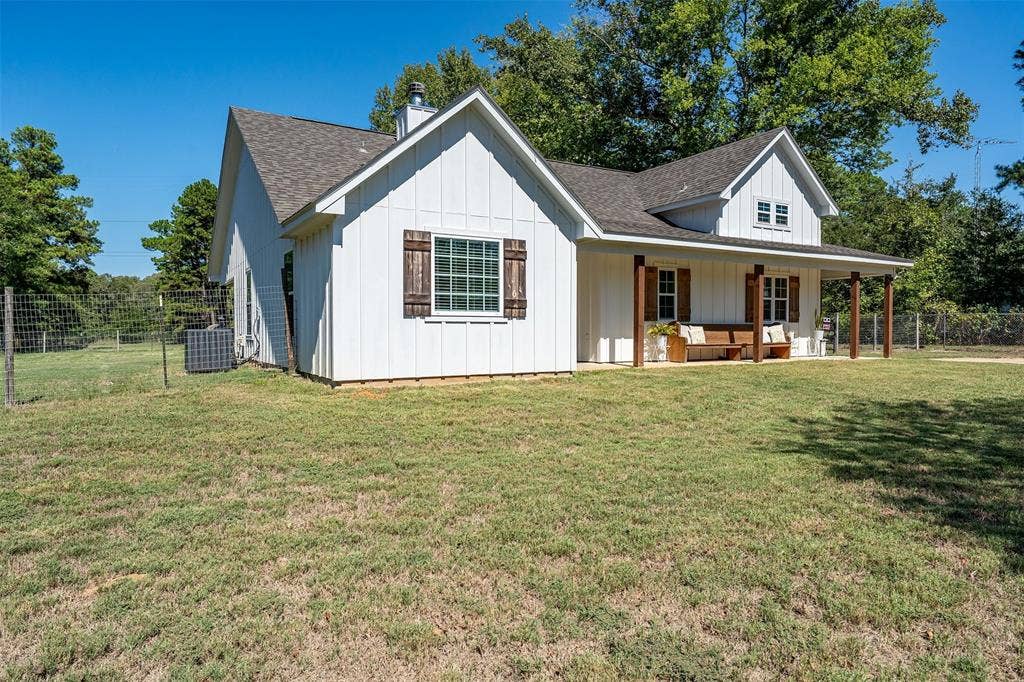 19731 County Road 4130, Lindale, TX 75771 White board-and-batten siding with a dark asphalt shingle roof