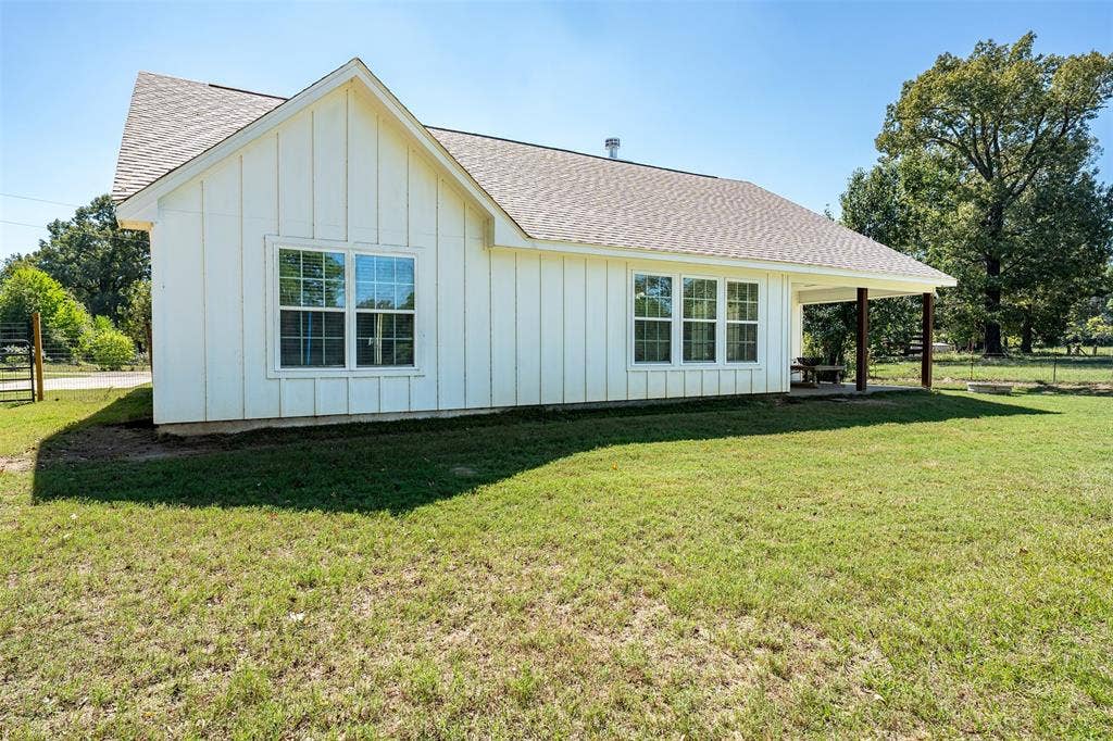 19731 County Road 4130, Lindale, TX 75771 White board and batten exterior with multiple windows and a covered patio