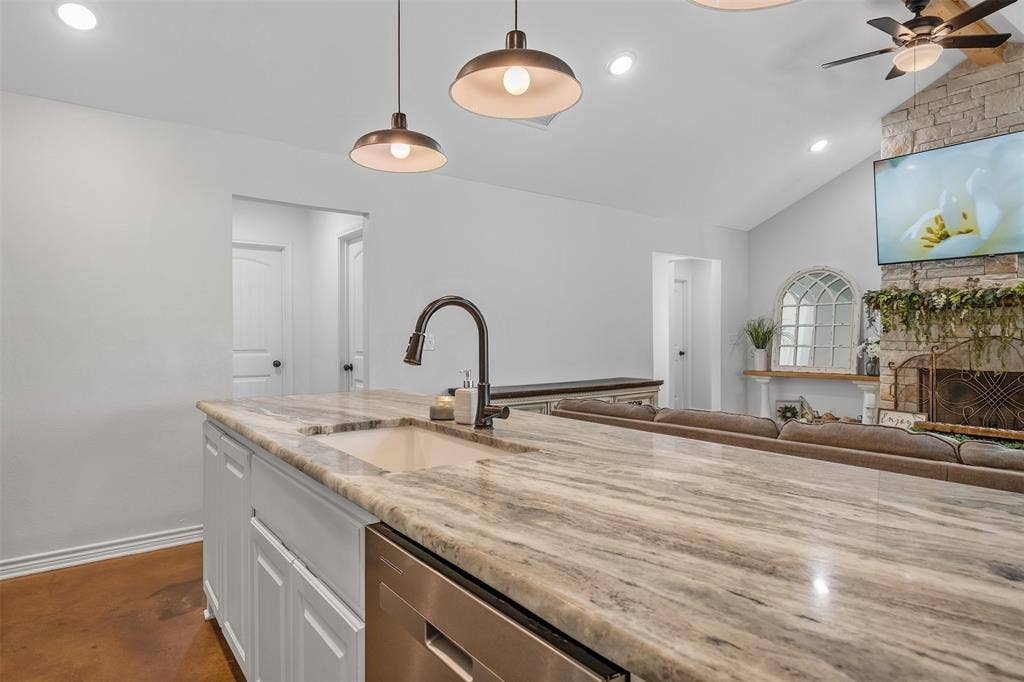 19731 County Road 4130, Lindale, TX 75771 Spacious kitchen island with integrated sink, stainless steel appliance, recessed lighting, and pendant fixtures